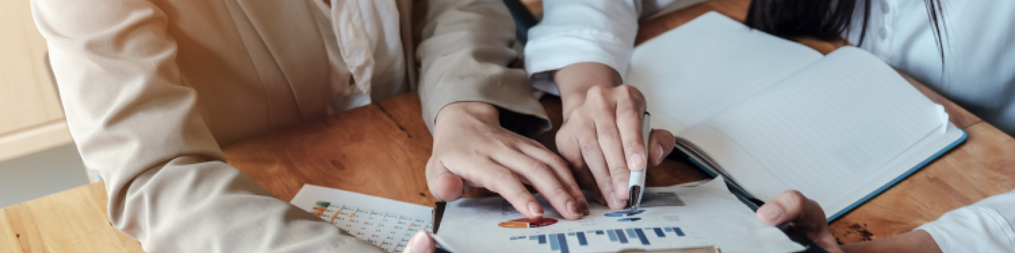 Two people looking at data on clip board