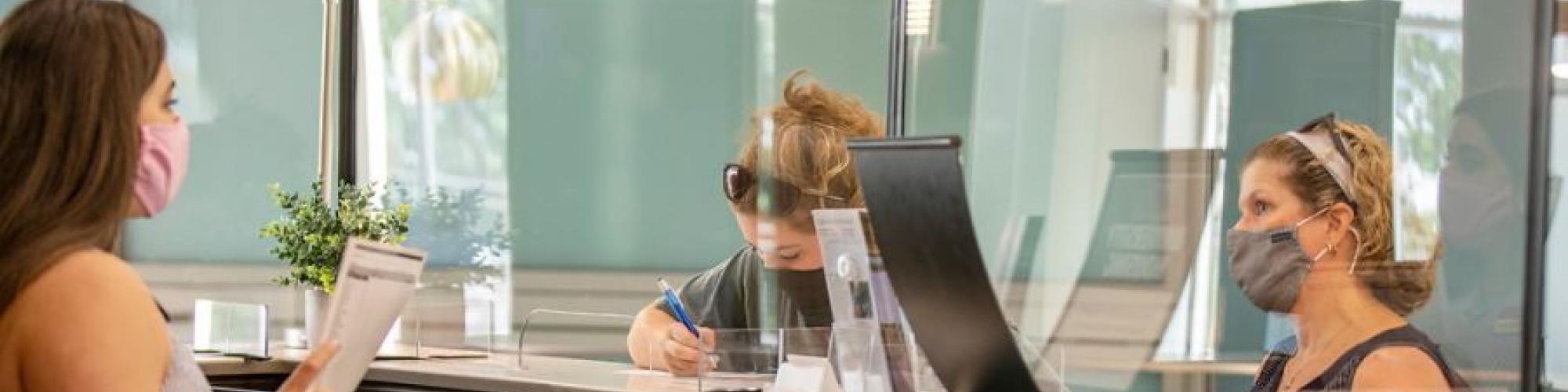 Patrons at a library wearing masks